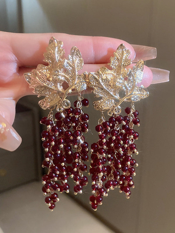 Geometrische Tropfenohrringe in Blattform mit Quasten