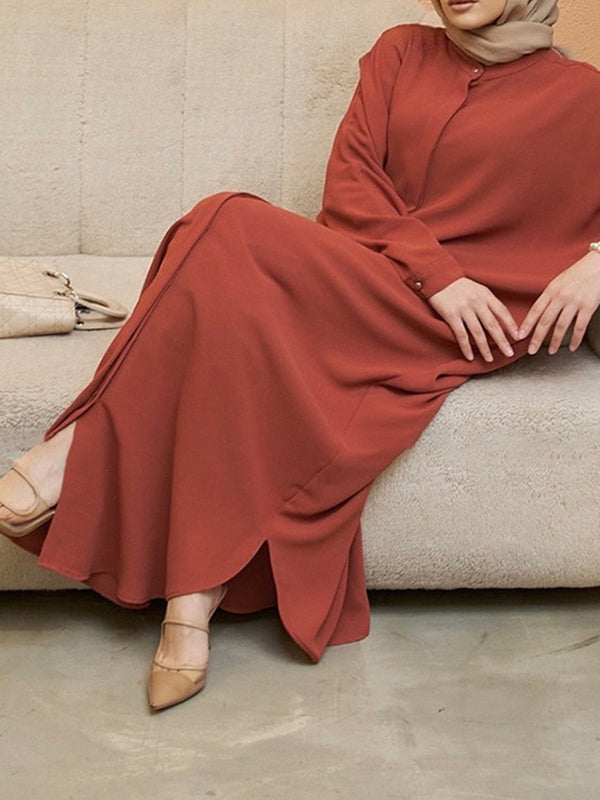 Robe longue musulmane ample à manches chauve-souris, boutonnée, couleur unie, fendue sur les côtés, col rond 