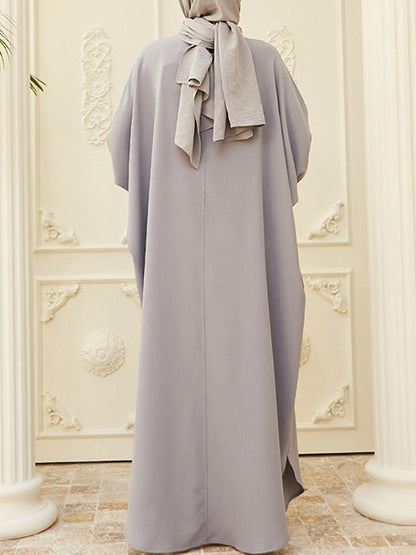 Robe longue musulmane ample à manches chauve-souris, boutonnée, couleur unie, fendue sur les côtés, col rond 